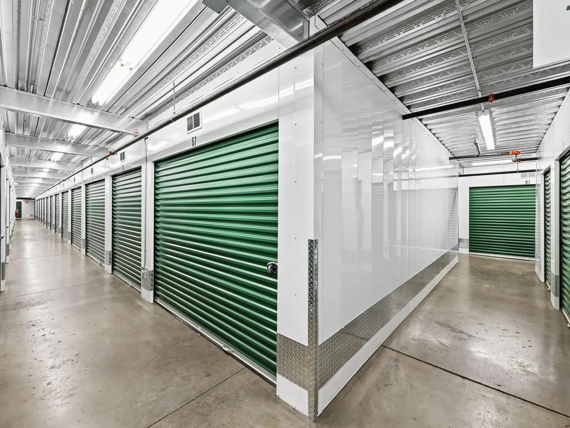 Interior-Row-Climate-Controlled-Self-Storage-Unit-Hallway-Green-Doors