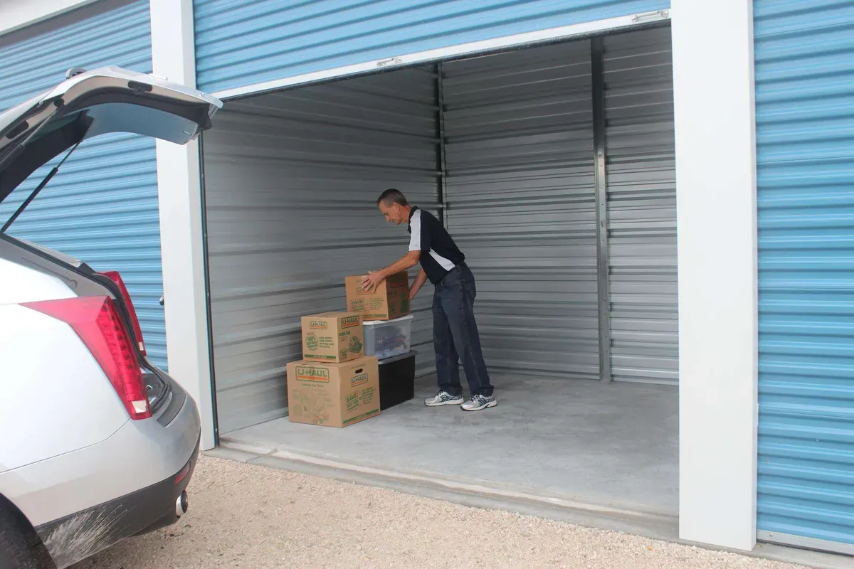 Man packing drive up self storage unit