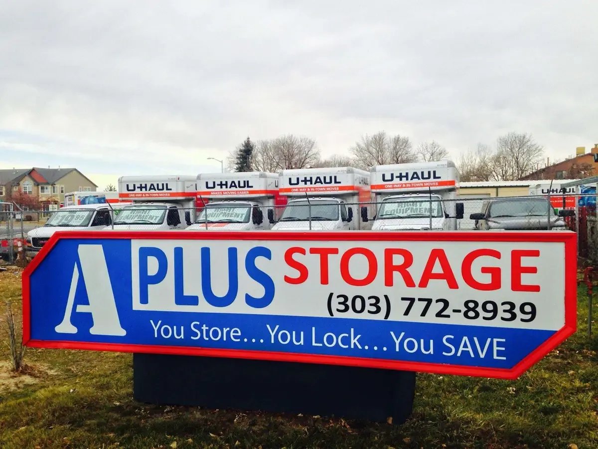Storage sign at self storage facility with rental trucks
